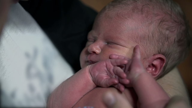 Detail of fondling a baby shot in slow motion