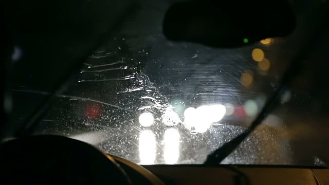 Car windscreen wipers actively remove gathered rain from windscreen at night