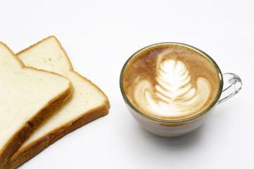 cup of latte art coffee with bread on white background
