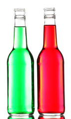 Colorful alcoholic beverages in glass bottles isolated on white