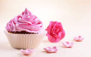 Delicious cupcake on beige background