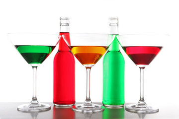 Colorful alcoholic beverages in glassware isolated on white