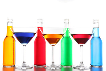 Colorful alcoholic beverages in glassware isolated on white
