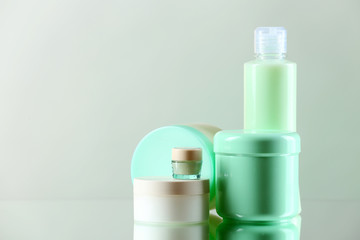 Cosmetic bottles on light background