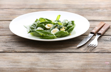 Salad with quail egg and basil in plate