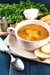 Composition with carrot soup, ingredients and herbs
