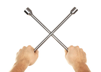 Cross wrench in male hands isolated on white