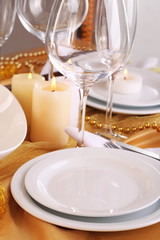Fototapeta na wymiar Beautiful holiday table setting in white and gold color