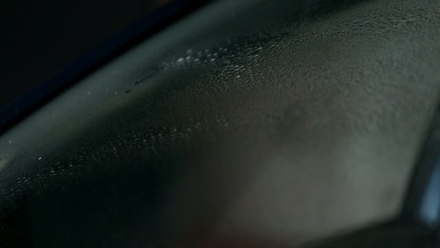 Spraying the cleaning fluid onto the windshield 