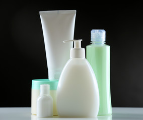 Group of cosmetic bottles on dark background