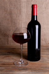 Red wine on table on sack background