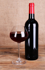 Red wine on table on sack background