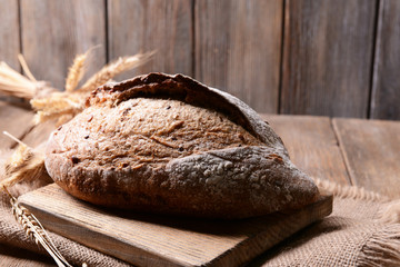 Tasty bread on table on wooden background