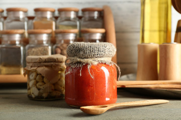 Different spices canned vegetables in glass bottles