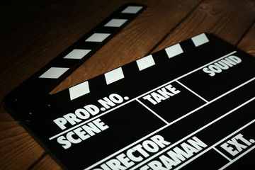 Fototapeta premium Movie clapper on wooden background