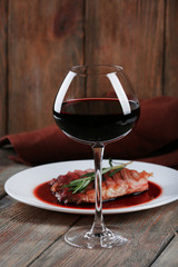 Grilled steak in wine sauce with glass of wine