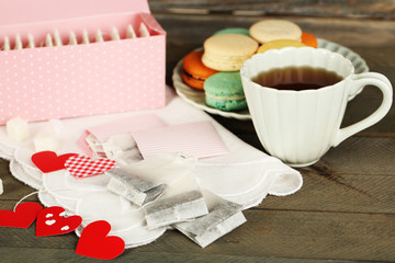 Heart shaped teabag tags, macaroons and cup of tea