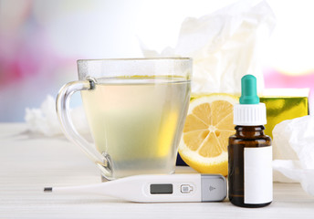 Hot tea for colds, pills and handkerchiefs