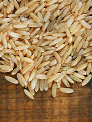 Rice grains on wooden background