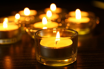 Burning candles on dark background