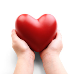 Heart in child hands isolated on white