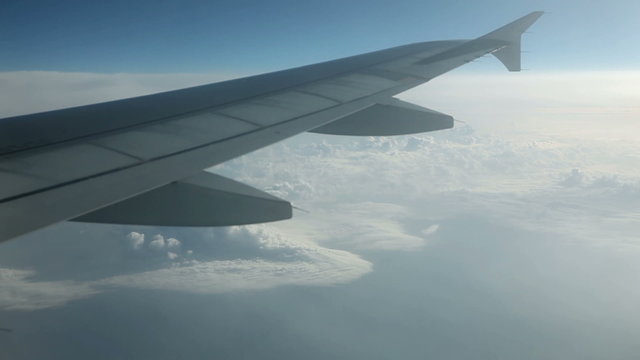 Beautiful cloudscape view from airplane with wing in front