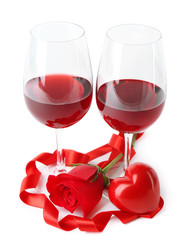 Composition with red wine in glasses, red rose, ribbon and