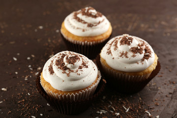 Delicious cupcakes on table close-up