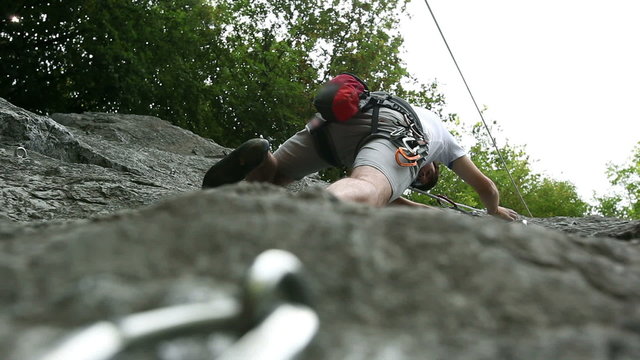 Young man rock climbing in beautiful nature