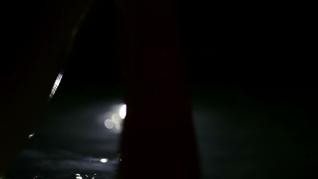 Close up shot of woman hands  in the outdoor pool in the night