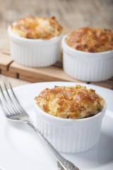 Mini potato casserole with red fish in a cocotte.