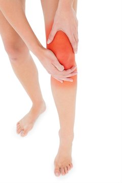 Closeup low section of a fit woman with leg pain