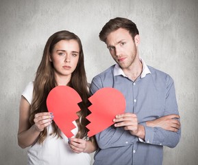 Obraz na płótnie Canvas Composite image of couple holding broken heart