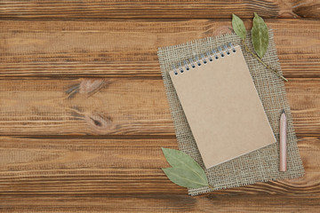 Blank notepad for copy space and herbs on wooden table!
