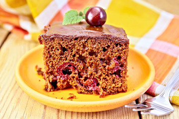 Cake chocolate with cherries and napkin on board