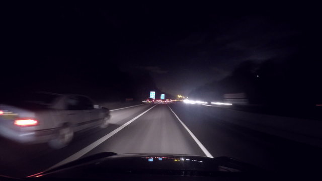Time lapse of a car speeding along a highway