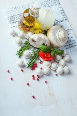 Tortellini and vegetables on white wooden background