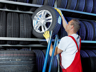 Car mechanic stores winter tires