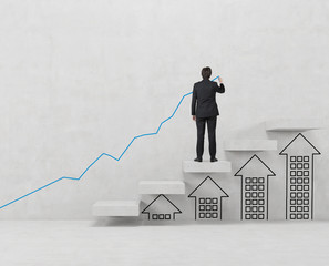 businessman drawing graph