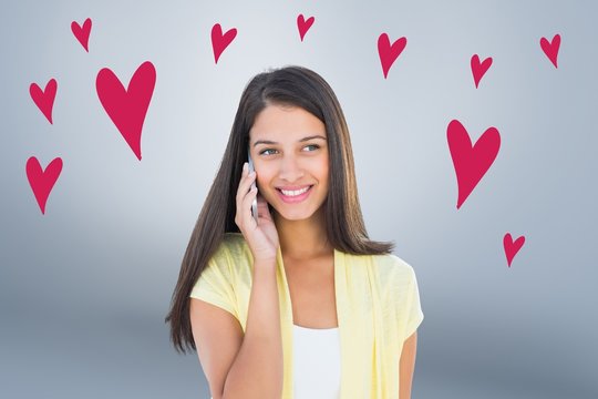 Composite image of happy casual woman on the phone