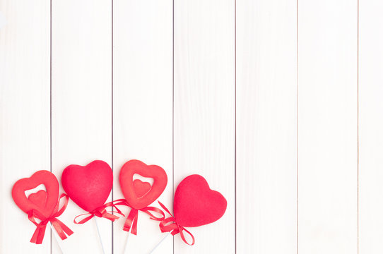 Four red hearts on sticks.