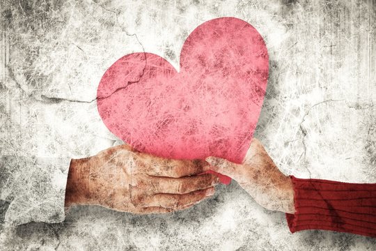 Composite image of couple holding heart