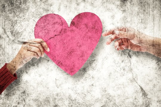 Composite image of couple holding a heart