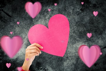 Fototapeta premium Composite image of couple holding a heart