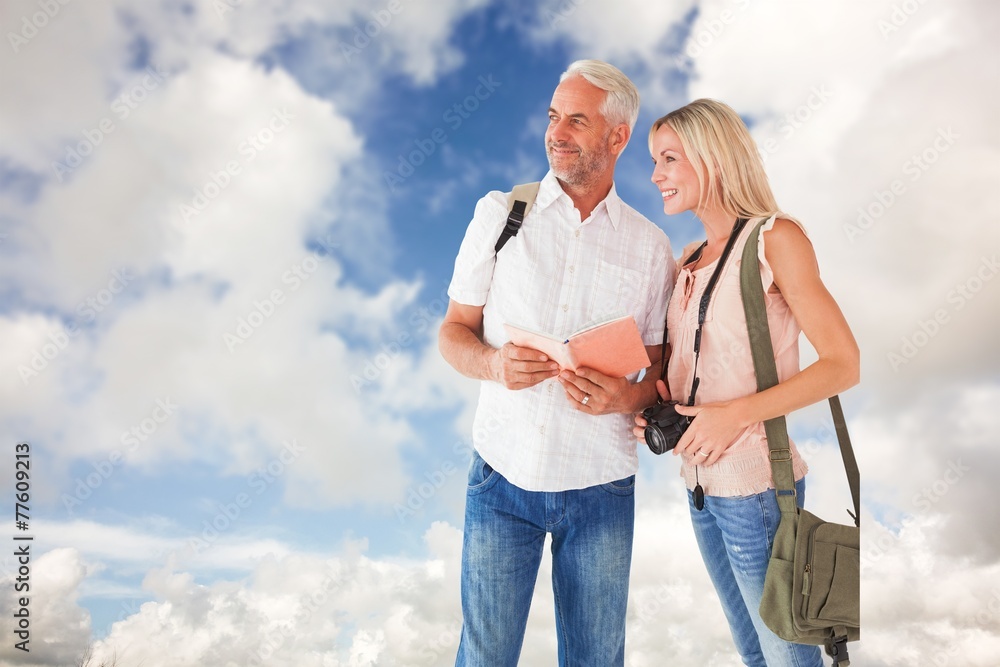 Poster composite image of happy tourist couple using the guidebook