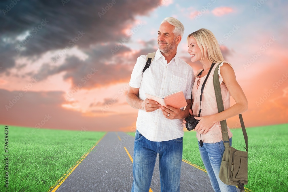 Poster composite image of happy tourist couple using the guidebook