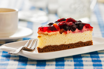 Cake on plate with fork and coffee cup