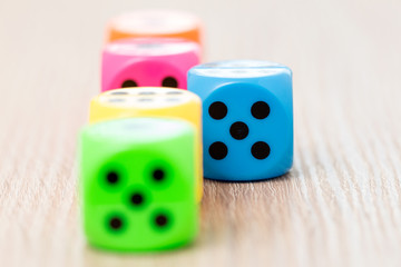 Colorful dice on the wooden surface
