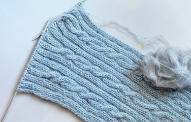 Hand knitting. Warm wool scarf