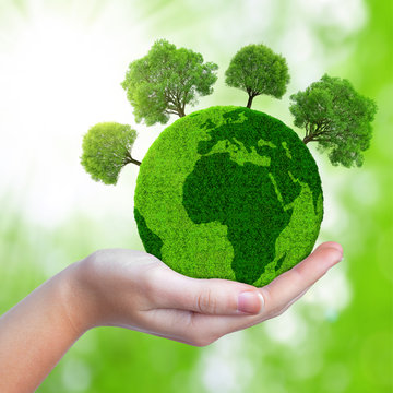 Green planet with trees in hand.